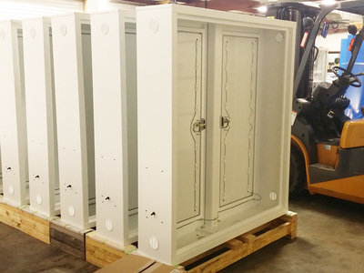 White cabinets sitting on pallets 