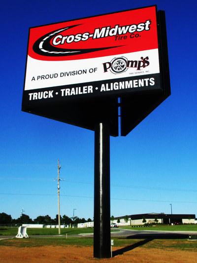 Cross Midwest Tire Co. Sign displayed on billboard.