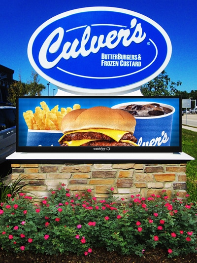 blue and white Culver's Butterburgers and Frozen Custard sign with food items displayed under sign