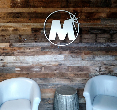 Magers Management Interior Logo on wood paneled wall