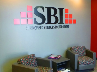 SBI Springfield Builders Incorporated acronym on gray wall