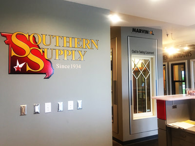 yellow and red Southern Supply Graphic on gray wall