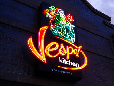 Vespo Kitchen sign with green neon graphic 