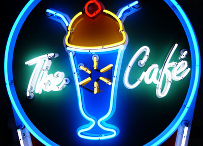 The Spark Cafe blue and yellow neon sign