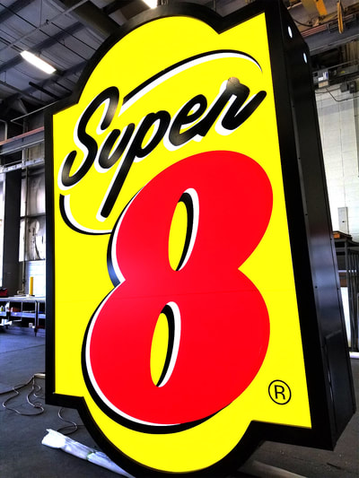yellow, red, and black super 8 hotel sign
