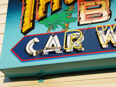 Car wash neon sign with palm trees