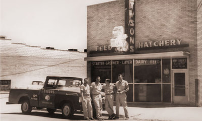 Vintage Tyson feed and hatchery sign in front or original location