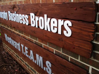 Business Brokers lettering on wooden background